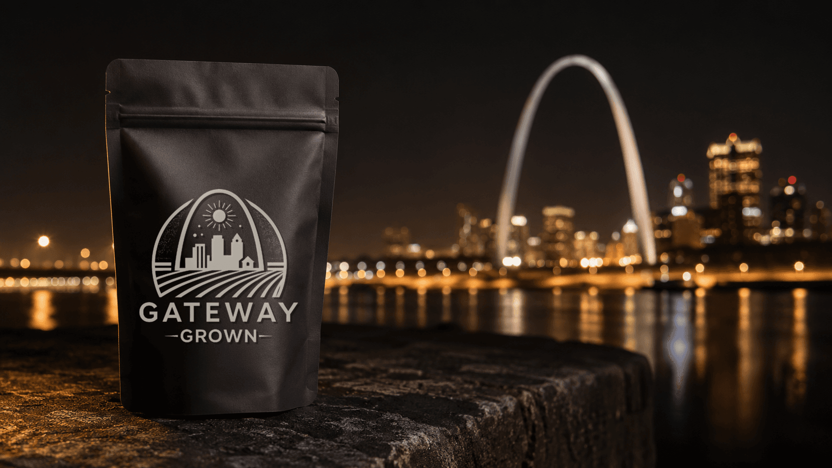 Black Gateway Grown pouch beside the St. Louis skyline at night